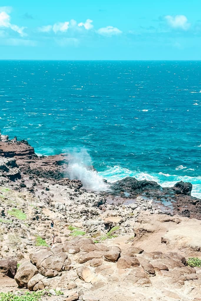 rugged coast of hawaii meeting the ocean with the nakalele blowhole pushing ocean water into the air