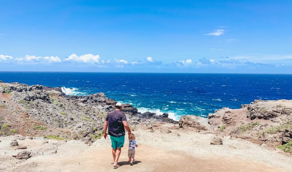 son and father enjoying a hike by nakalele point blowhole