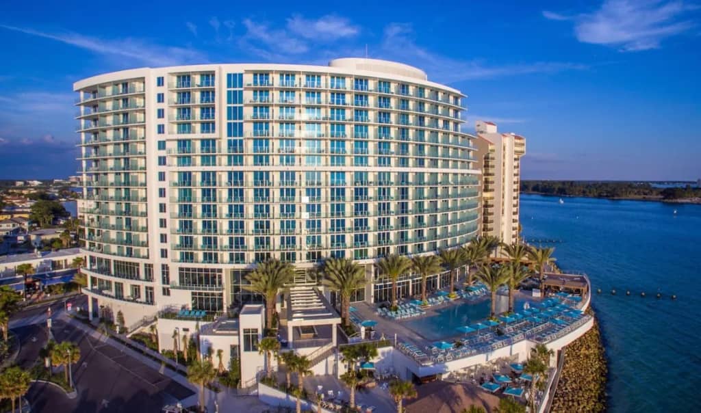 aerial view of opal sands, curve shaped high rise on the beach with windows that have ocean views