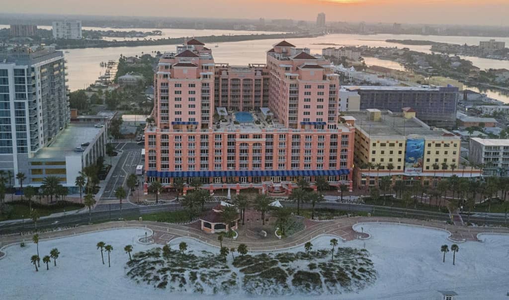 aerial view of the hyatt regency hotel in clearwater beach. huge pink building with rooftop pool on the beach