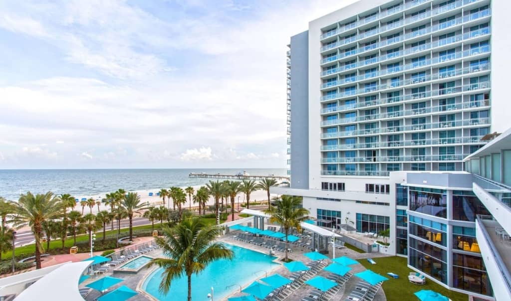 one of the high rise towers of the wyndham grand as well as landscaping and pool in clearwater beach