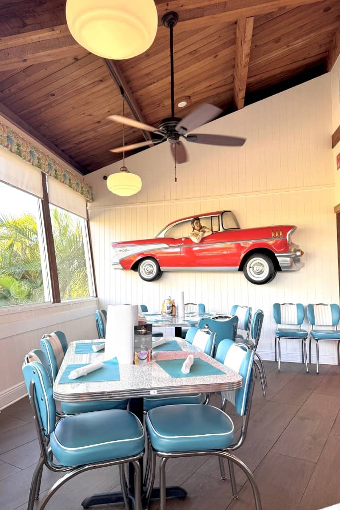 retro turquoise chairs and tables with wood ceiling and retro car design on the wall at cheeburger cheeburger in sanibel