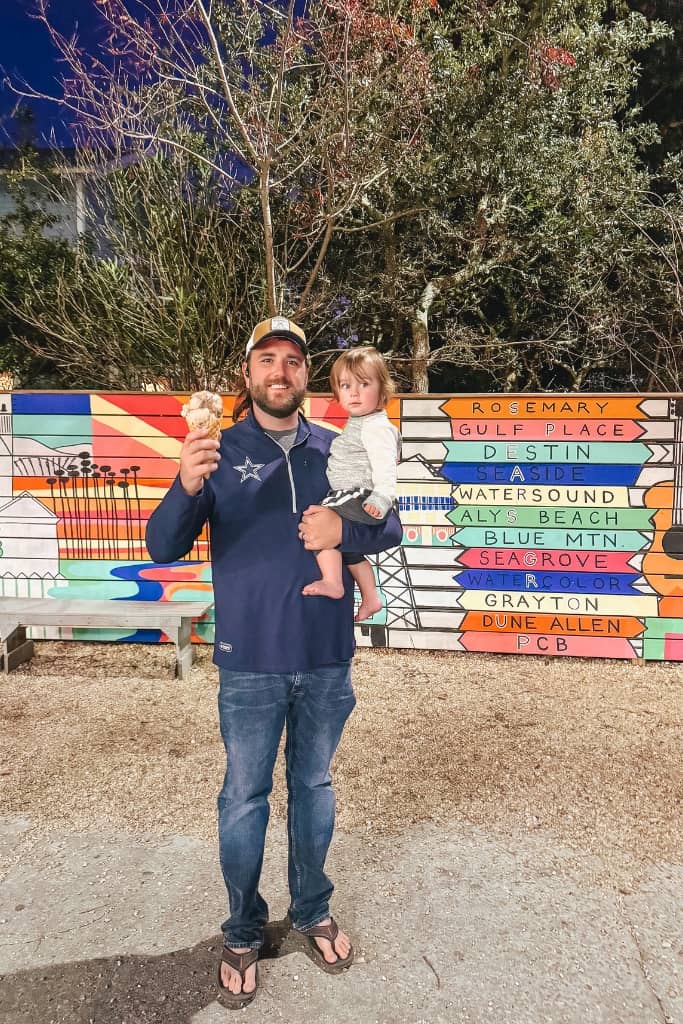 dad holding a toddler with ice cream in front of colorful background with list of fun vacation destinations