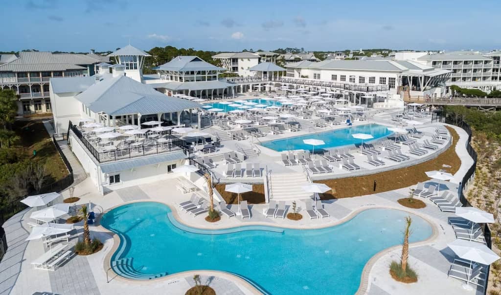 white hotel buildings with multiple pools overlooking the beach at the watercolor inn