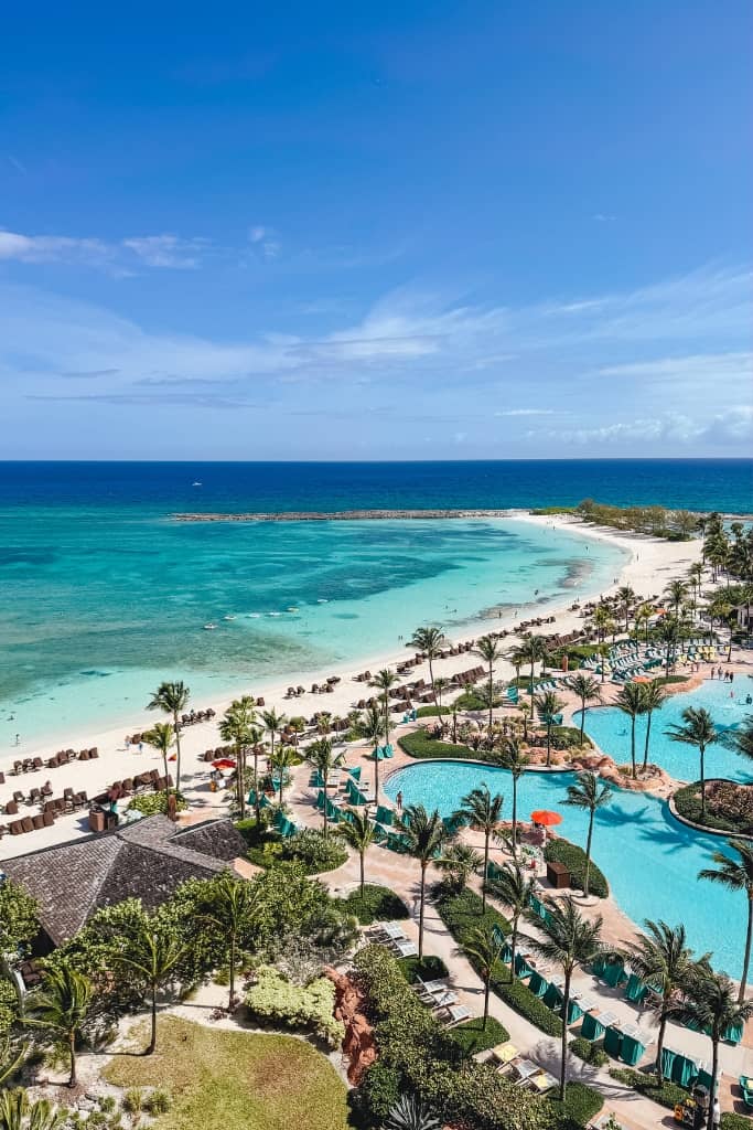 view of cove beach and pools at atlantis taken from hotel room balcony on a sunny day