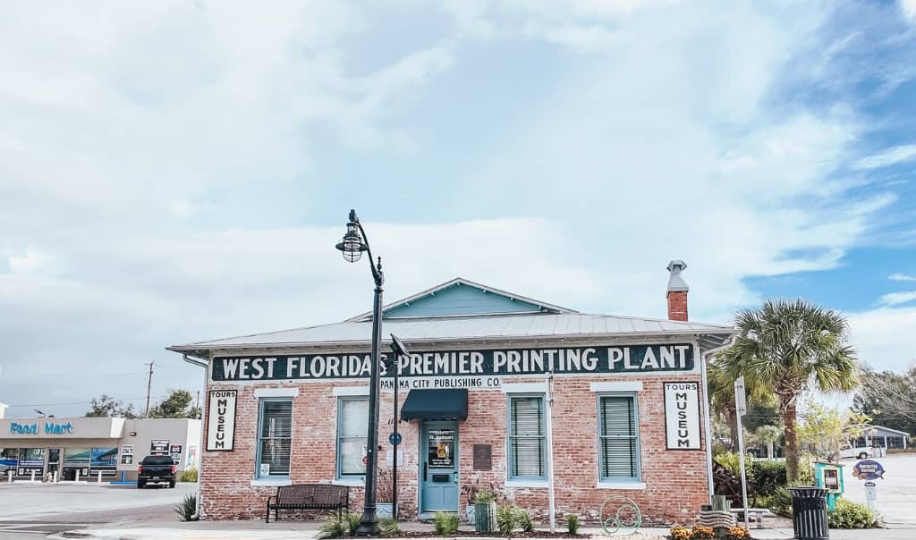 brick building that says publishing museum on a black sign